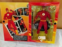 Box front opened showing figure inside blister and printed filmstrip graphics