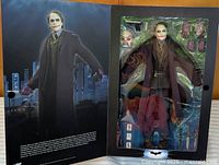 Front flap open showing boxed Joker figure and accessories