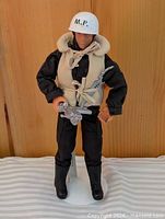 Full view of figure on stand with accessories