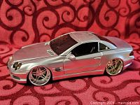 Left side view of silver Mercedes-Benz SL die-cast car showing body and wheels