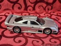 Left side view of silver Mercedes-Benz CLK GTR die-cast model showing body profile and wheels