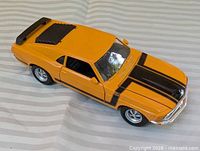 Left front three-quarter view of yellow Maisto Mustang Boss 302 model