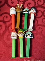 All seven Christmas themed PEZ dispensers laid out