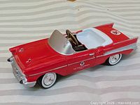 Full left front perspective of red pressed steel Texaco pedal car