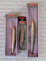 Three boxed Rapala lures side by side