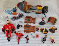 All figures, vehicle parts and accessories laid out on striped surface