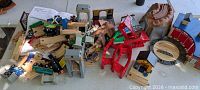 Pile of wooden track, trains, bridges, tunnel, buildings, figures, instruction sheets