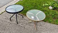 Both round patio tables showing colors, frames and glass tops