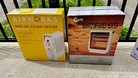 Front view of both boxed heaters showing product names and images