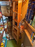 Full view of wooden folding ladder standing in storage area