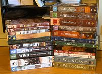 Two stacks of assorted DVD box sets and movies as listed