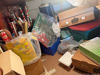 Overview of lot showing boxed tree, gift wrap, totes, Big Bird bag, cardboard boxes
