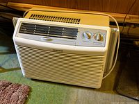 Front view showing grille, logo, control panel and attached cord