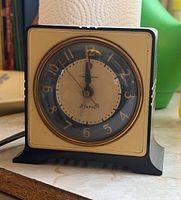 Front view showing dial, beige face, gold bezel, case details