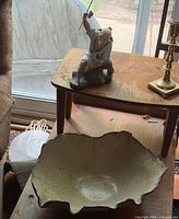 Overall view of porcelain figure and ruffled bowl on table