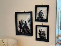 all three framed silhouette artworks on wall
