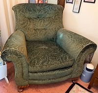 Front view of green upholstered armchair