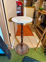 Full view of pedestal stand showing marble top, turned wooden column, and base