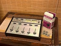 Top view showing Ritron MV-8C mixer with boxed AC/DC adapter and two plug adapters
