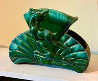 Front view showing leaping deer design and glossy green glaze