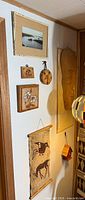 Overall view showing mask, textile hanging, framed print, plaques and bamboo roll-up