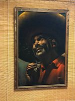 Full view of framed velvet painting hanging on wall