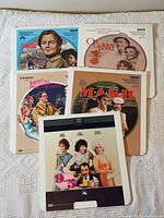 Five CED VideoDisc movie caddies laid out