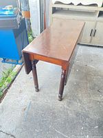 Table with leaves down showing rectangular form and turned legs