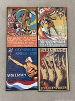 Four wood-mounted Olympic poster reproductions arranged side by side