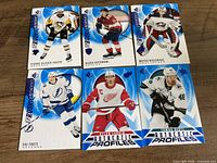 All six Upper Deck SP hockey cards laid out on wood surface