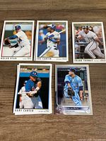 Five baseball cards laid out, each player visible