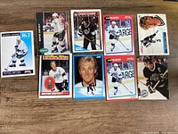 Overview of eight Wayne Gretzky trading cards laid out on table