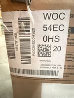 Manufacturer label on carton showing model WOC54EC0HS20 and Whirlpool branding