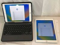 Front view of both iPads, one in keyboard case showing setup screen