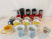 Front view showing full assortment of mugs and travel tumblers
