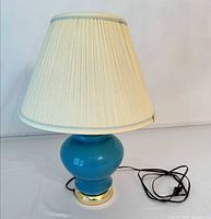 Lamp front view showing base, shade, cord