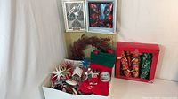 Group showing boxed ornaments, wreath, loose ornaments, crackers