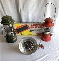 Full lot showing two lanterns, heater, boxed solar panel, small adapter