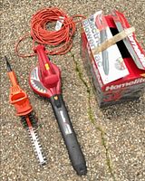 Leaf blower, hedge trimmer, extension cord, and box group shot