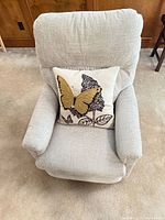 Front view of light gray recliner with butterfly pillow