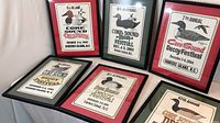 Six framed posters arranged to show years and mat colors