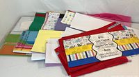 Stack of assorted tissue paper sheets in various colors and patterns