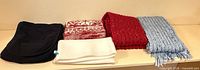 Scarves and neck gaiters lined up