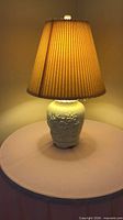 Full view of lamp showing ceramic base, shade, finial
