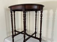 Mahogany oval folding table, side view showing turned legs and stretcher
