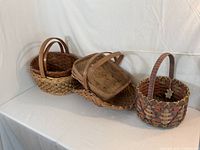 Five assorted handled baskets grouped together, showing overall appearance