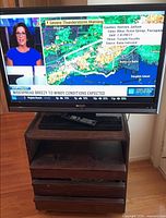 Front view of Sharp TV displaying broadcast