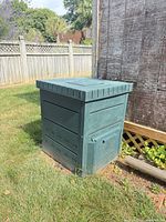 Full view of compost bin next to shed