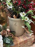 Beige stoneware crock stamped 4 filled with faux floral stems