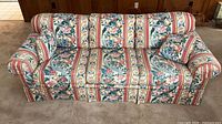 Front view of floral stripe three-seat sofa